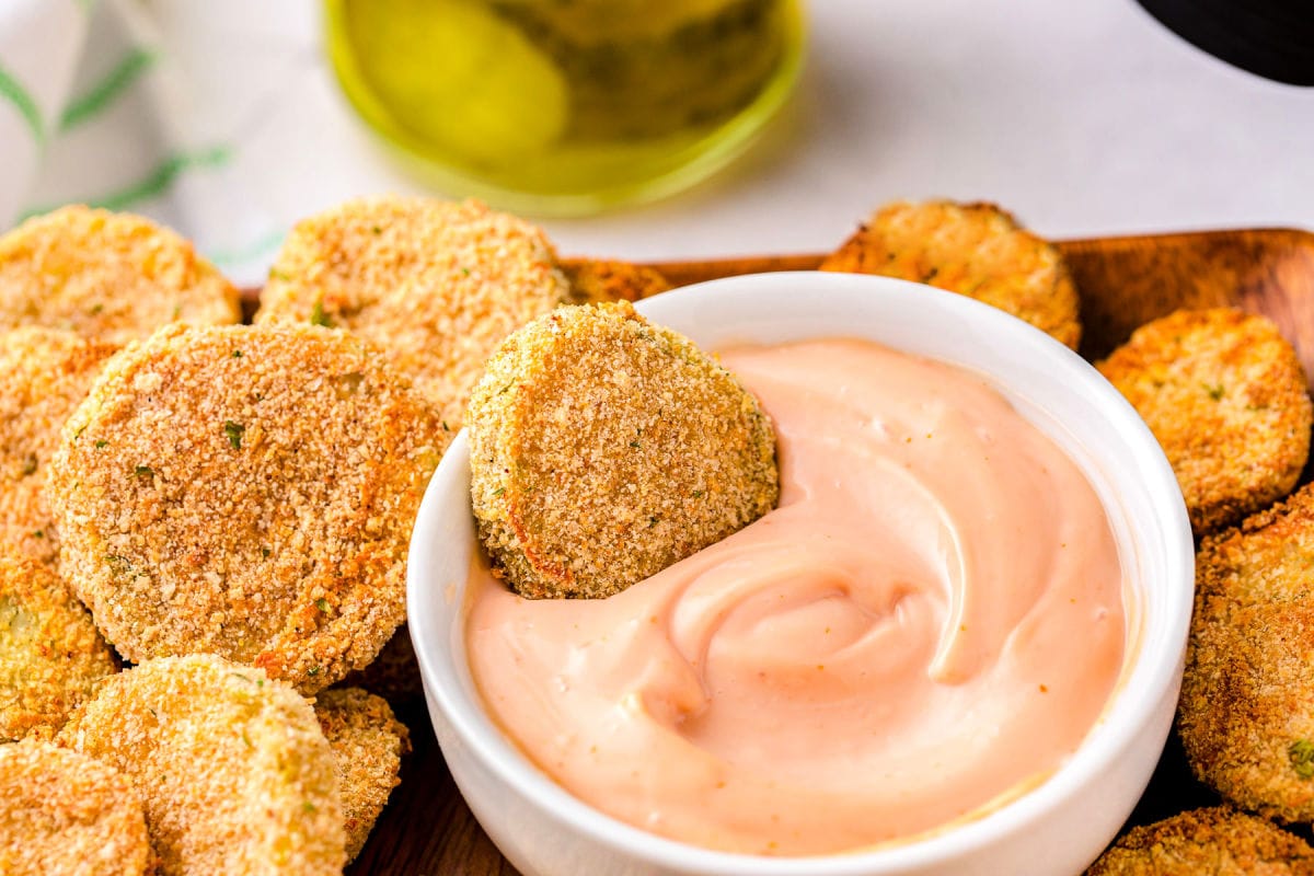 fried pickles being dipped in fry sauce