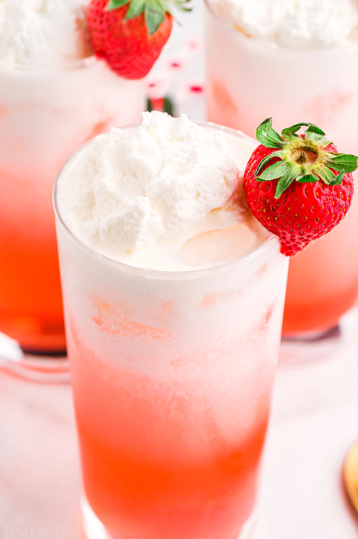italian cream soda topped with whipped cream and a strawberry.
