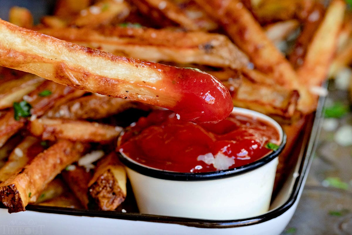 fry being dipped in ketchup.