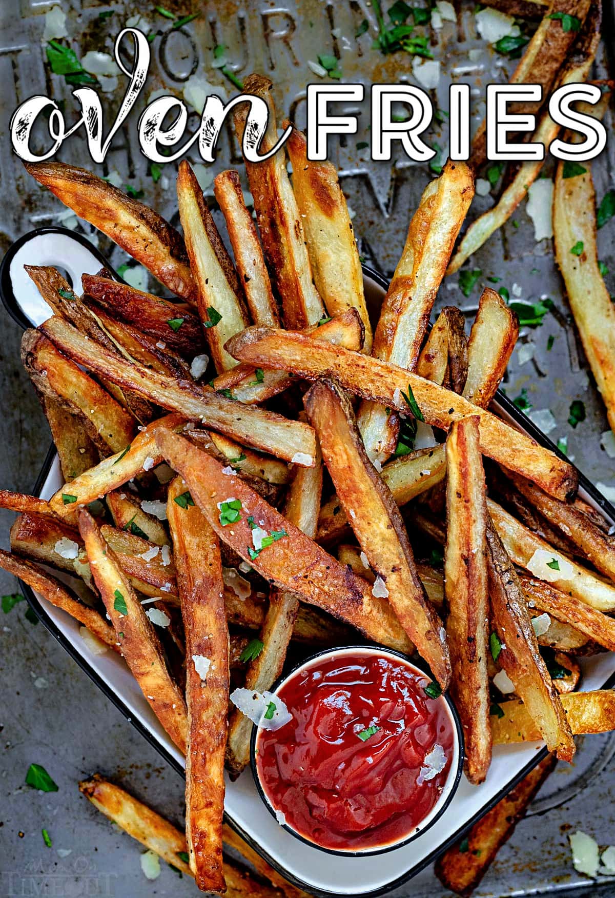 pile of oven fries on baking sheet with small bowl of ketchup. title overlay on top of image.