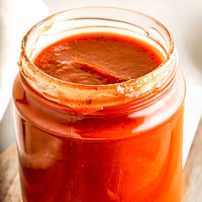 bbq sauce in glass jar on wood board.