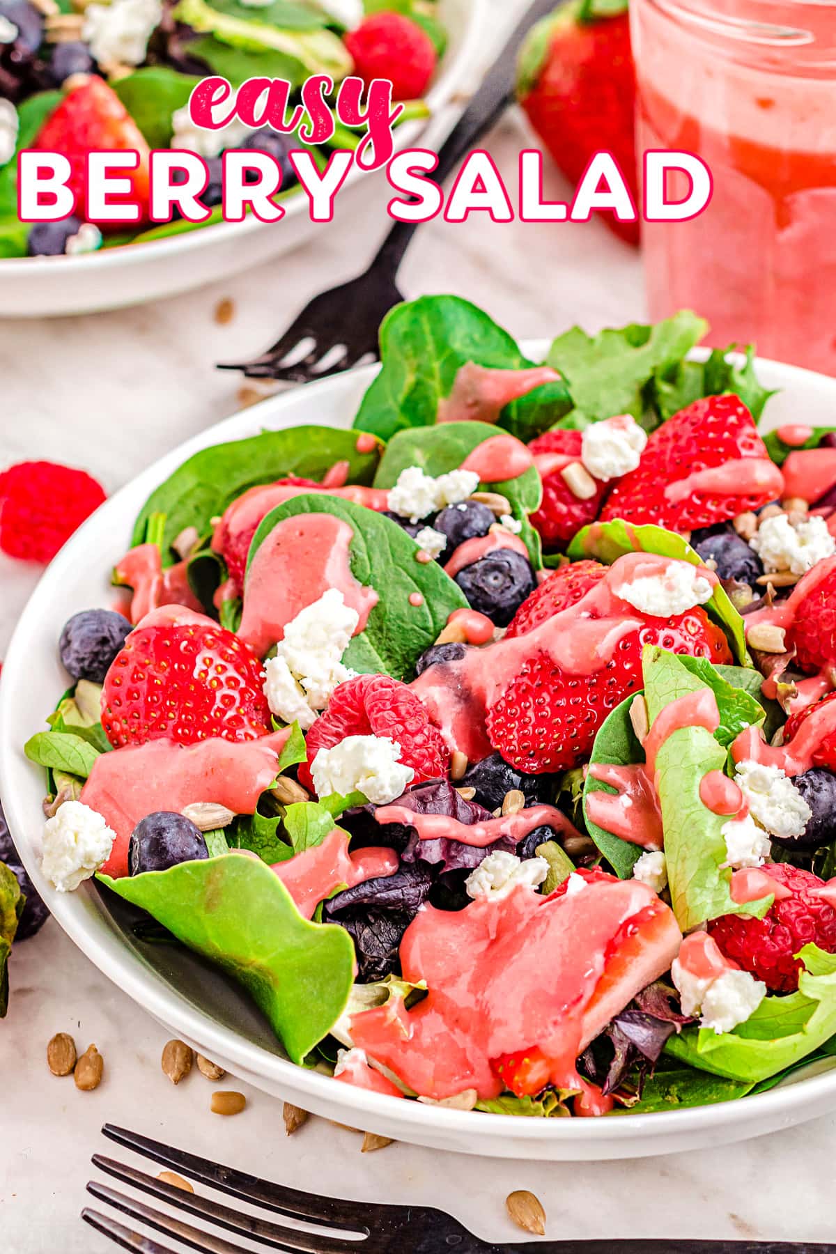 top down look at berry salad with raspberries, strawberries and blueberries. title overlay at top of image.