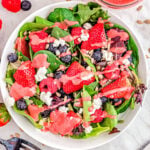 top down view of berry salad with raspberry vinaigrette ready to serve.