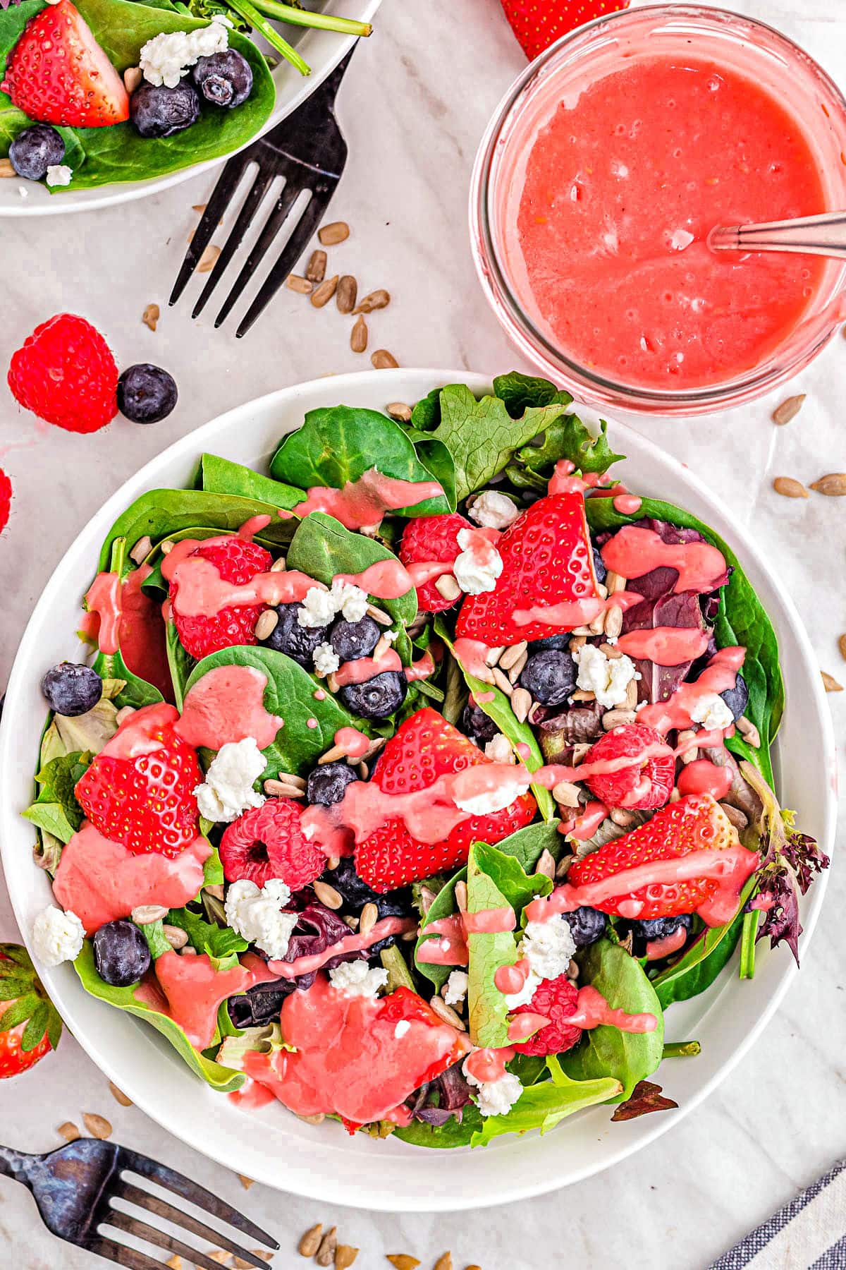 top down view of berry salad with raspberry vinaigrette ready to serve.