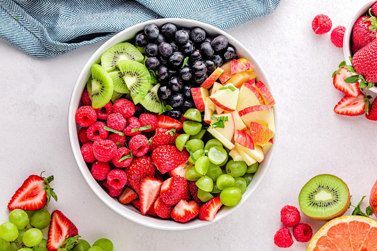 fruit salad ingredients in bowl ready to be tossed together.