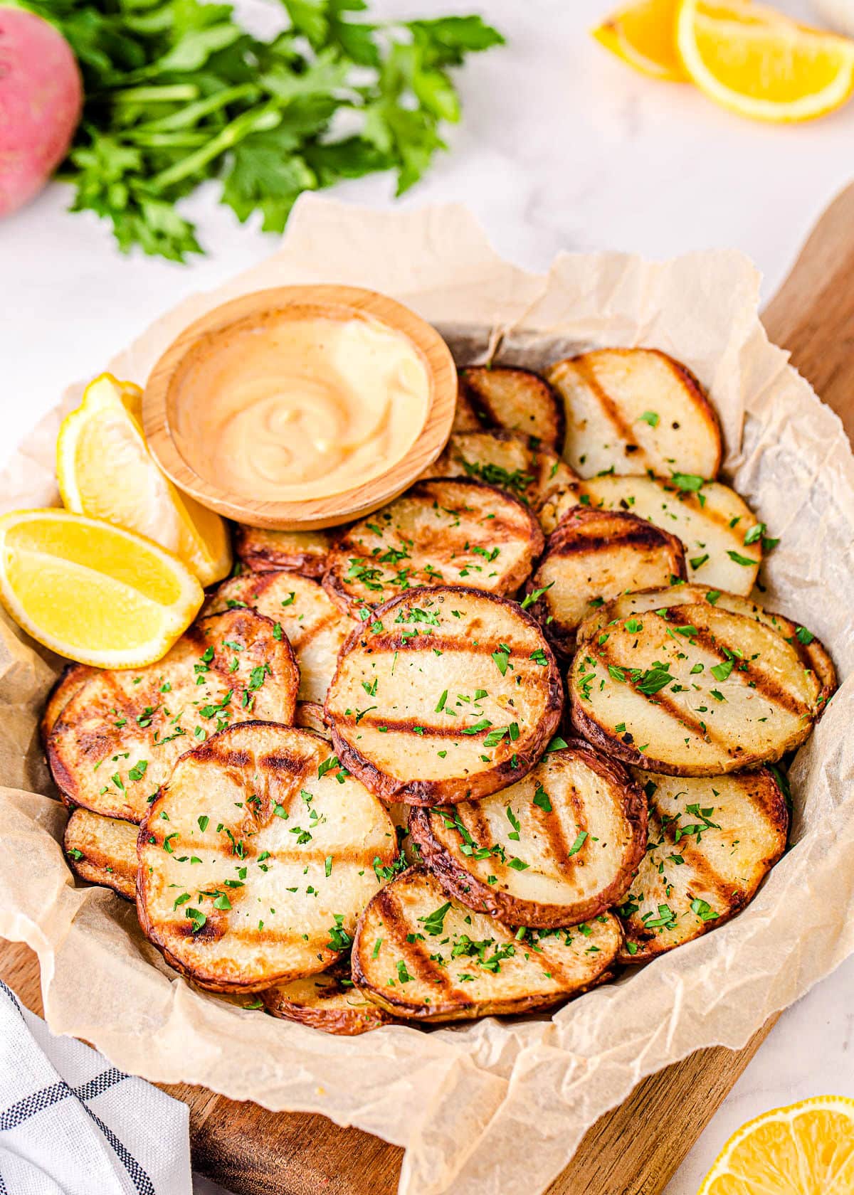 easy grilled potatoes served with dipping sauce on large plate.