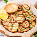 easy grilled potatoes served with dipping sauce on large plate.