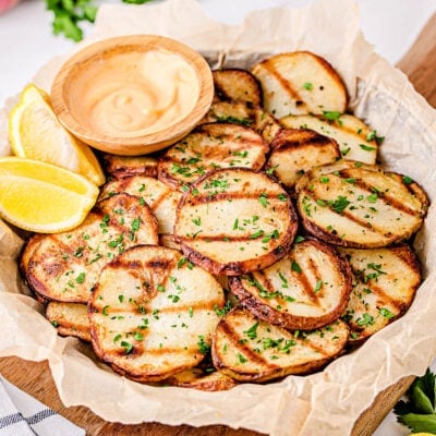 easy grilled potatoes served with dipping sauce on large plate.