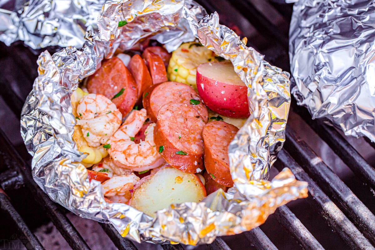 shrimp foil packets being made on the grill.