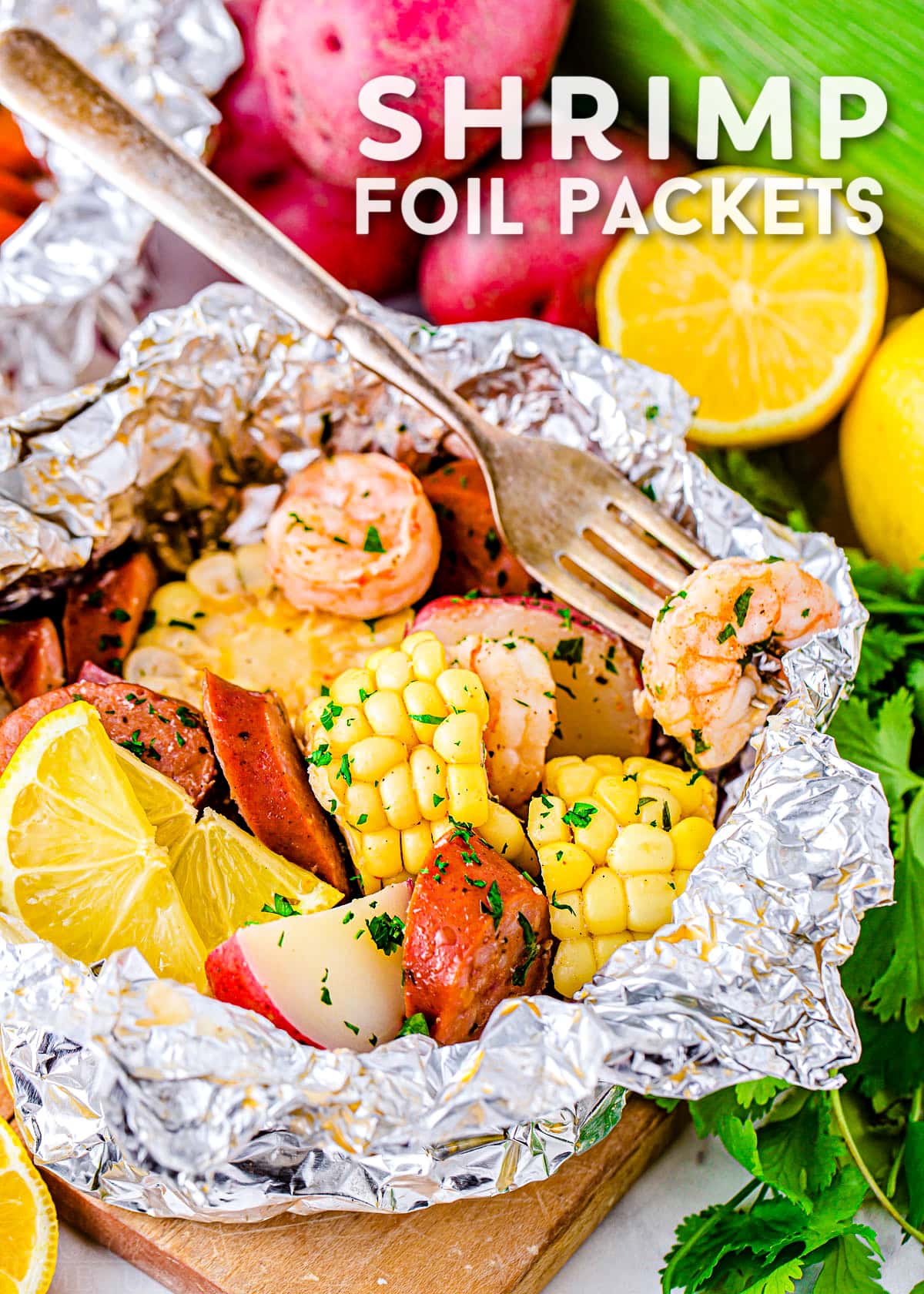 shrimp boil cooked in foil with corn, sausage, shrimp and potatoes. Title overlay at top of image.