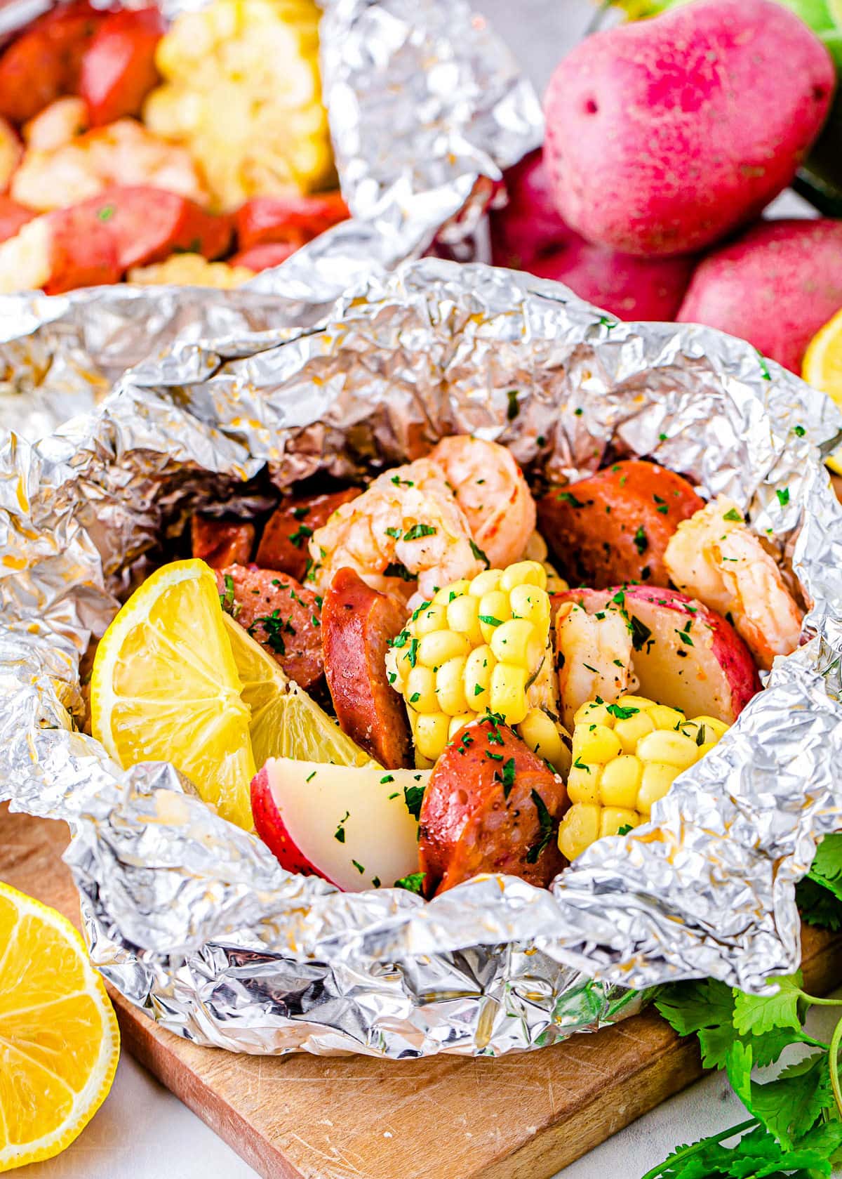 grilled shrimp boil made in foil packets with corn, sausage and shrimp.