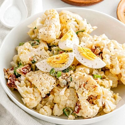 cauliflower salad made like potato salad in white bowl ready to serve.