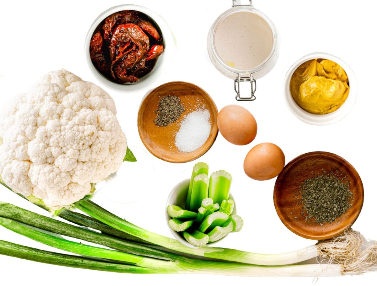 ingredients for cauliflower salad all laid out on white surface and ready to use.