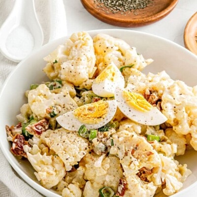 cauliflower salad made like potato salad in white bowl ready to serve.