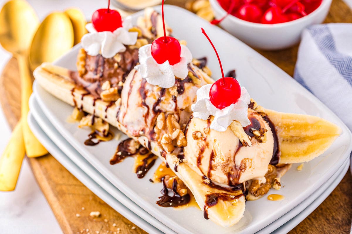 sundae made with bananas, ice cream, whipped cream, and cherries.