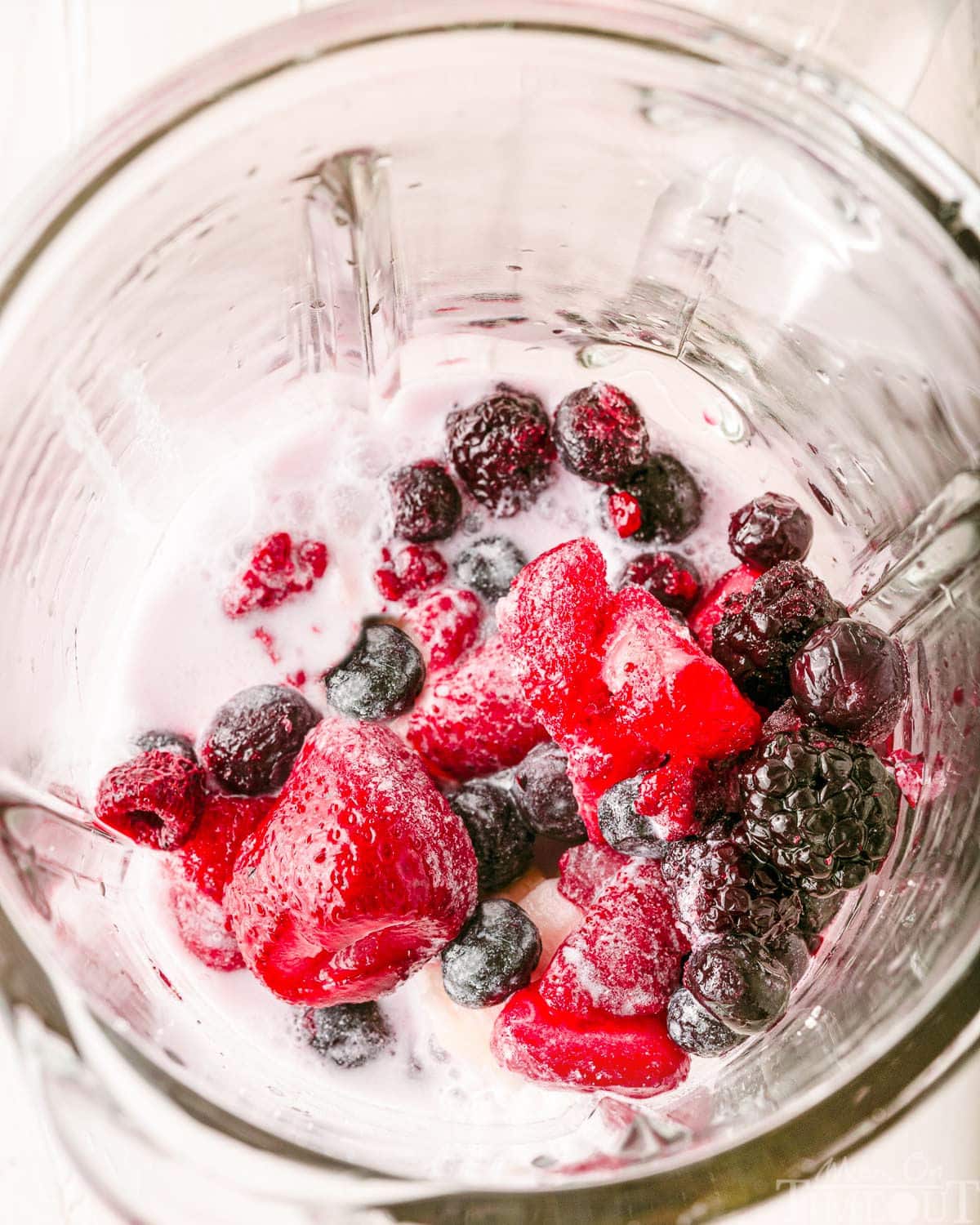 berry smoothie ingredient in a blender ready to be blended.