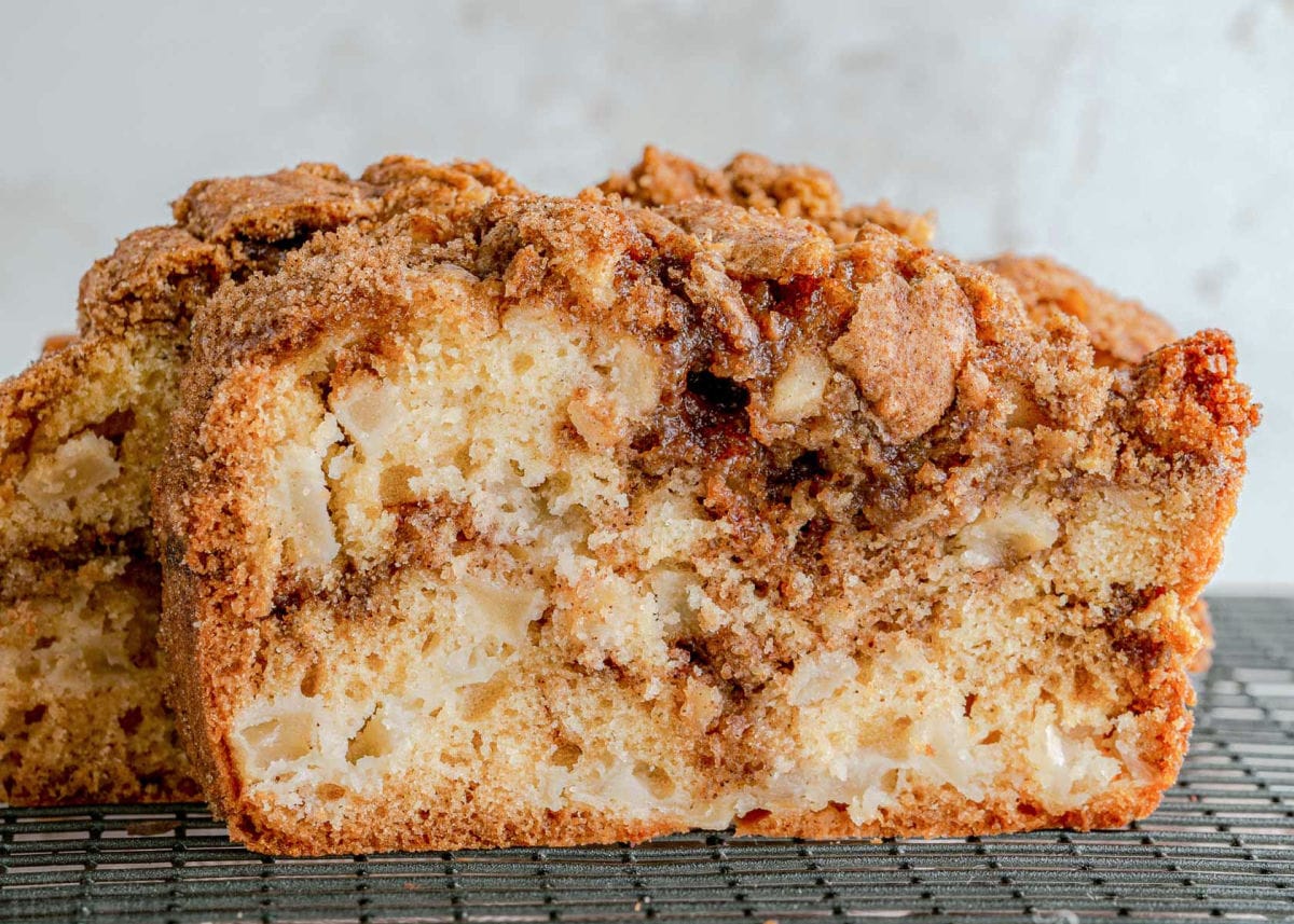 front view of slice of apple bread sitting on a cooling rack.