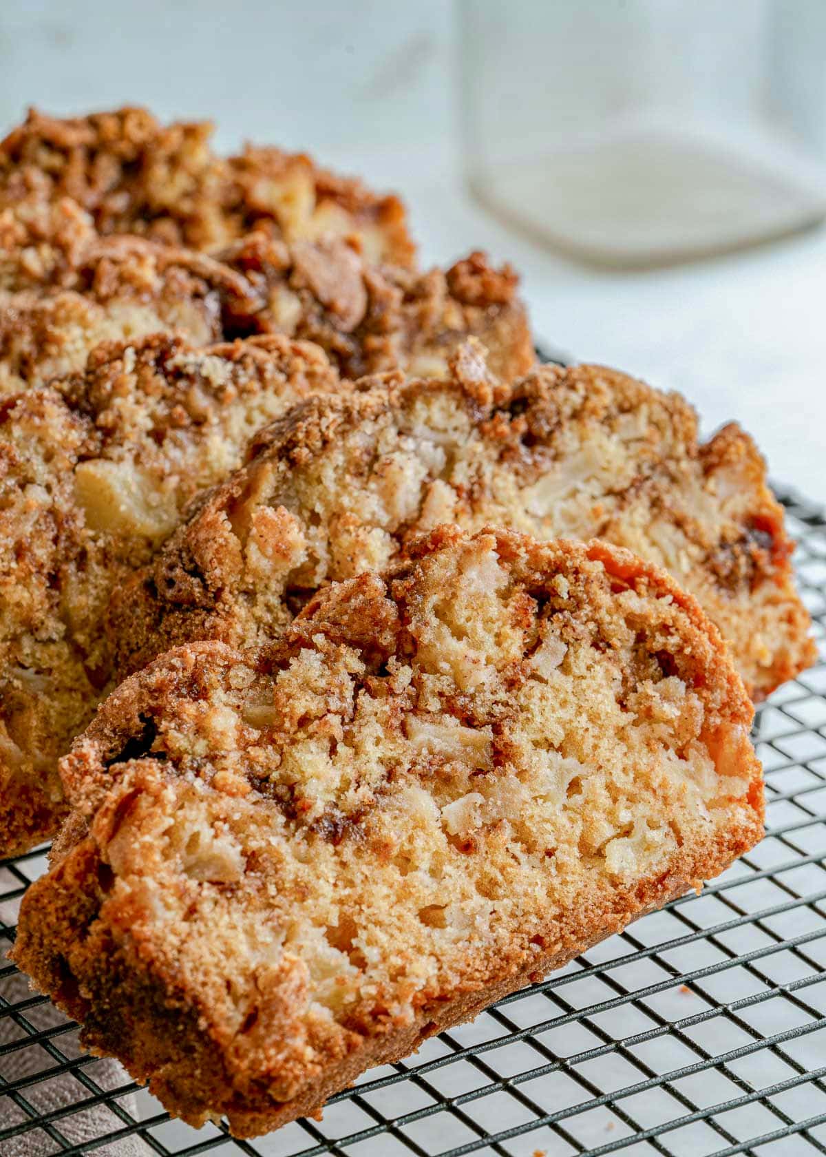 four slices of apple bread on black cooling rack.