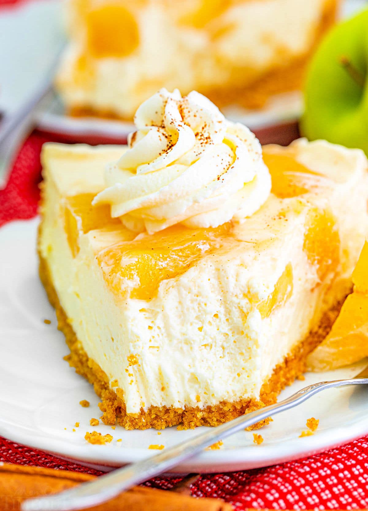 look at the creamy texture of this no bake apple cheesecake with a forkful removed from a slice.