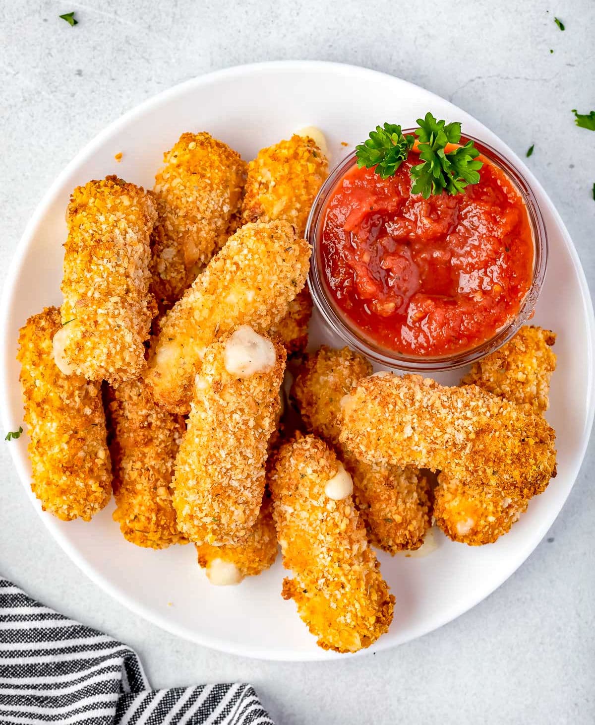 top down look at frozen mozzarella sticks that have been cooked in air fryer ready to be enjoyed.