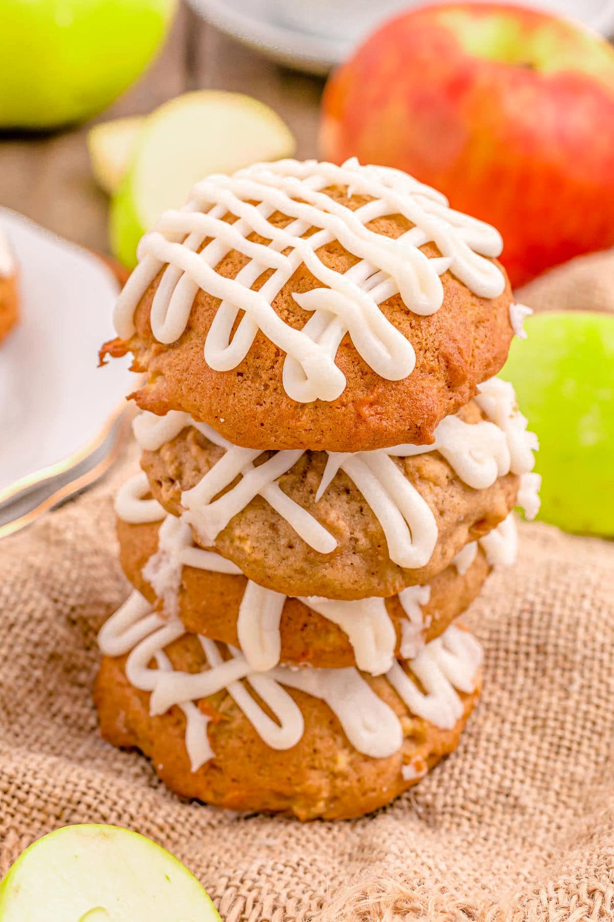 three apple cookies stacked on each other sitting on burlap.