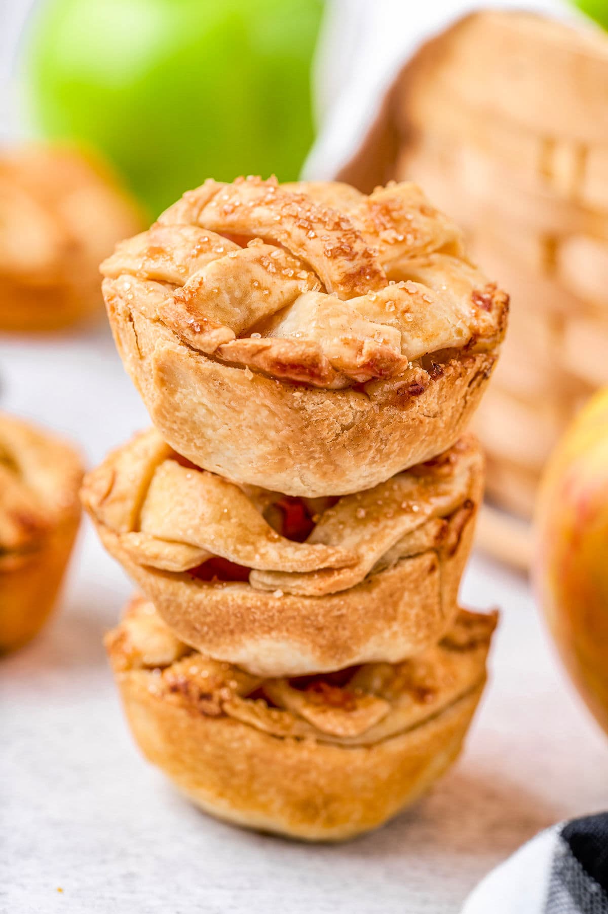 three individual apple pies stacked on top of each other.
