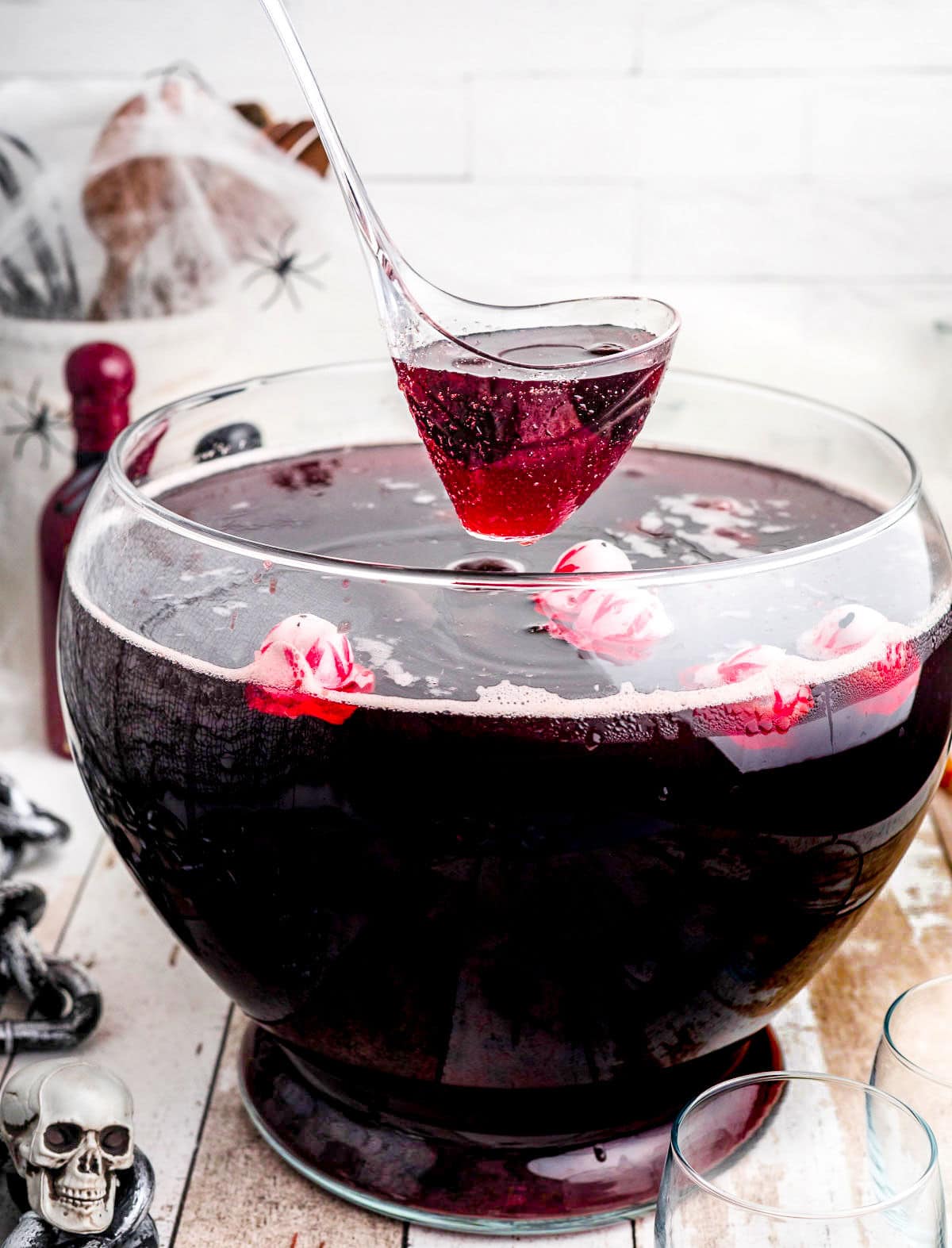 punch being ladled out of a large punch bowl.