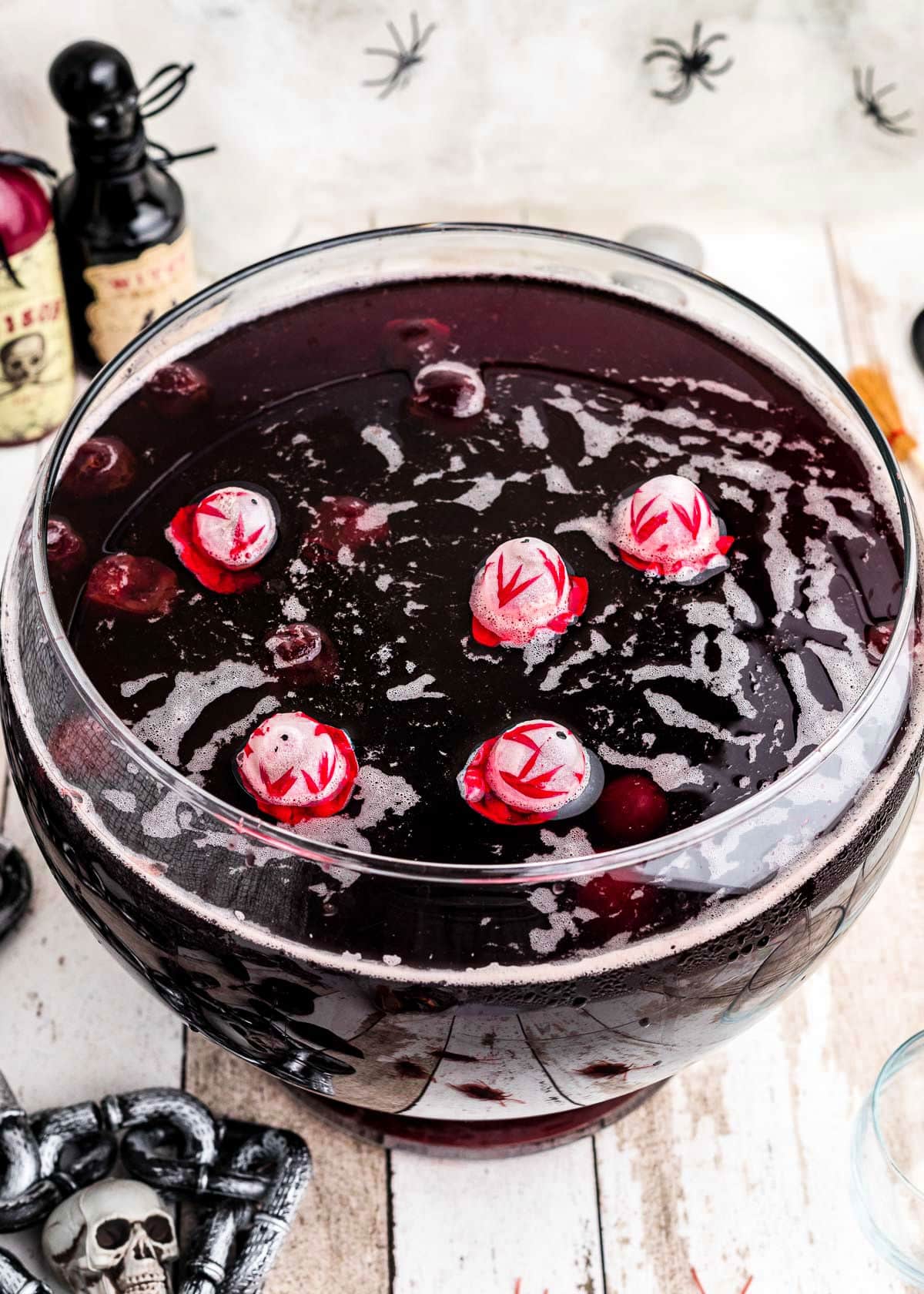 top down look at halloween punch in a glass punch bowl with skull ice cubes.
