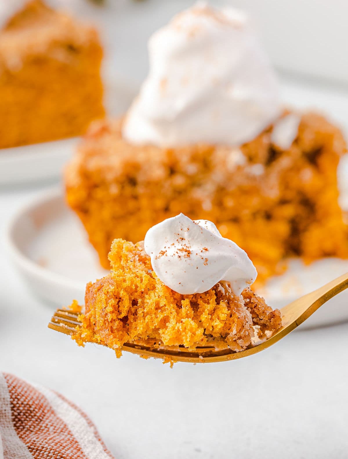 bite of pumpkin coffee cake with whipped cream