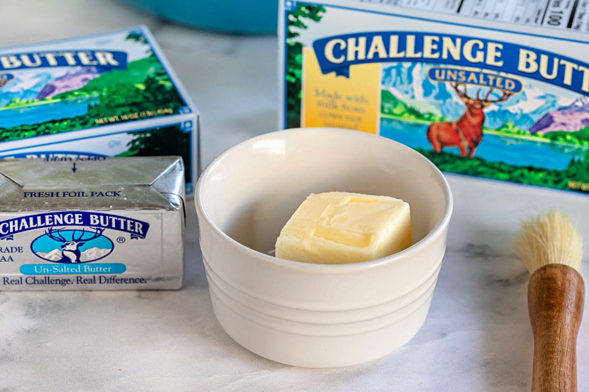 butter in a small white bowl ready to be melted.