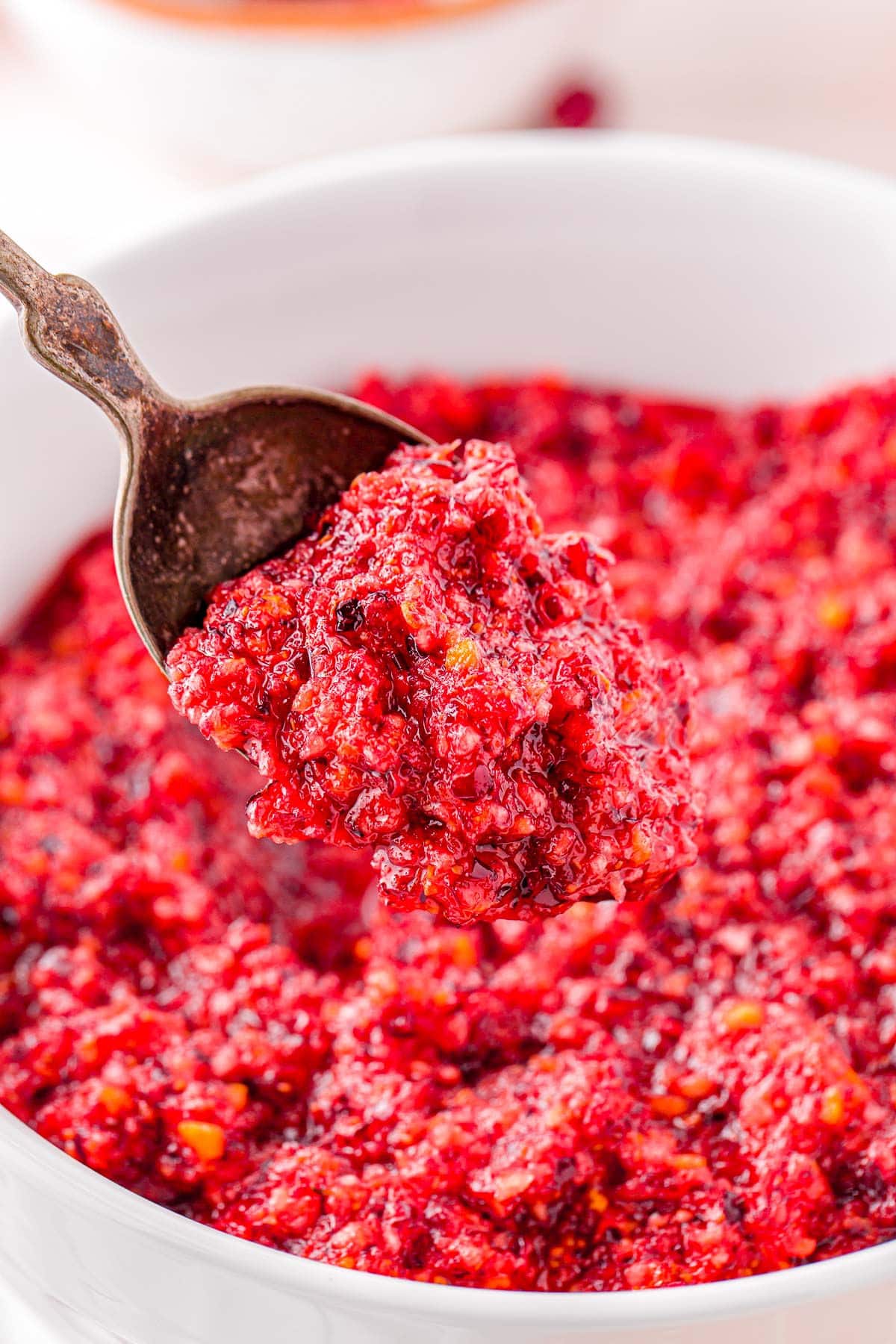 spoonful of relish held above white bowl.