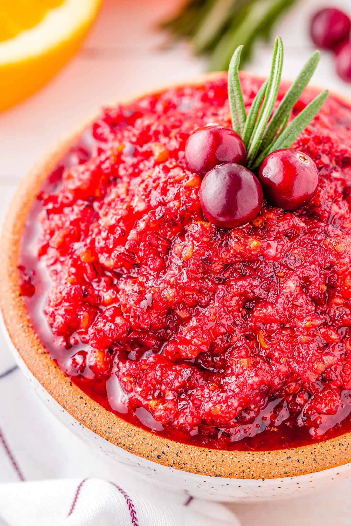 close up look at cranberry relish in a small white bowl ready to serve.
