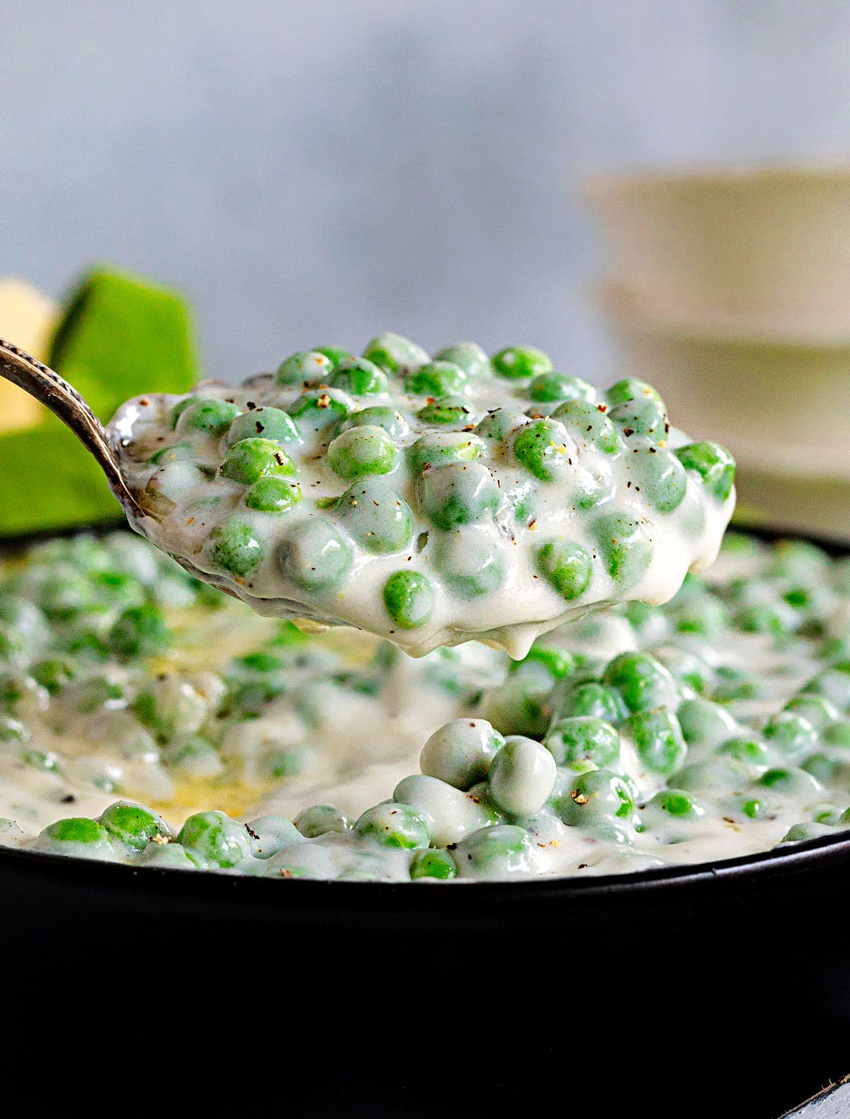 large spoonful of peas ready to be served.