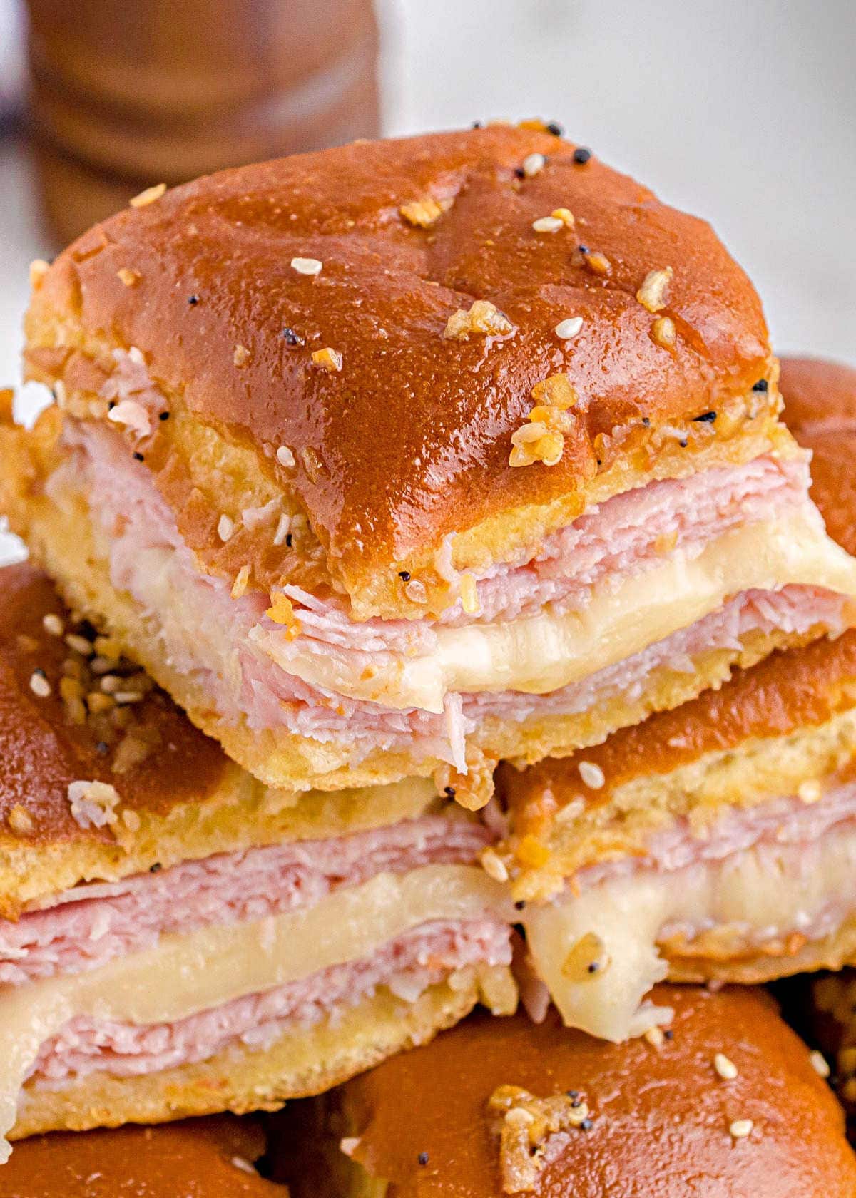 close up look and hot ham and cheese sliders with everything bagel topping and ready to eat.