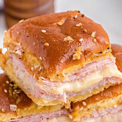 close up look and hot ham and cheese sliders with everything bagel topping and ready to eat.