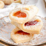 three kolackzi cookies stacked on each other on two gold rimmed plates.