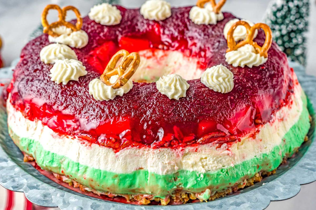 layered jello salad on metal cake stand.