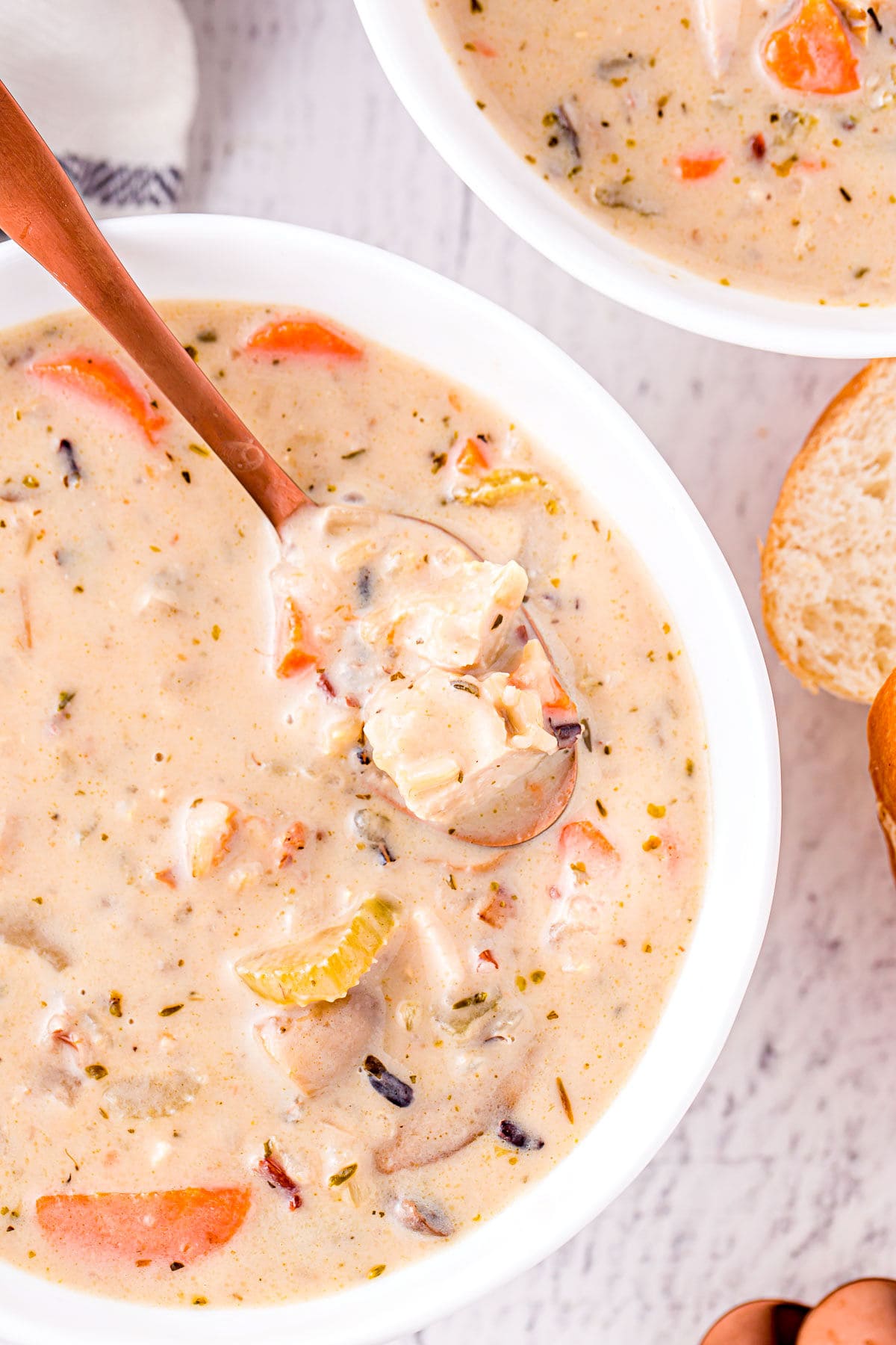 spoonful of turkey and wild rice soup in the serving bowl.