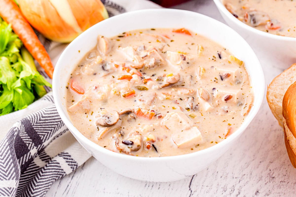 white bowl filled with turkey soup made with leftover turkey and wild rice.