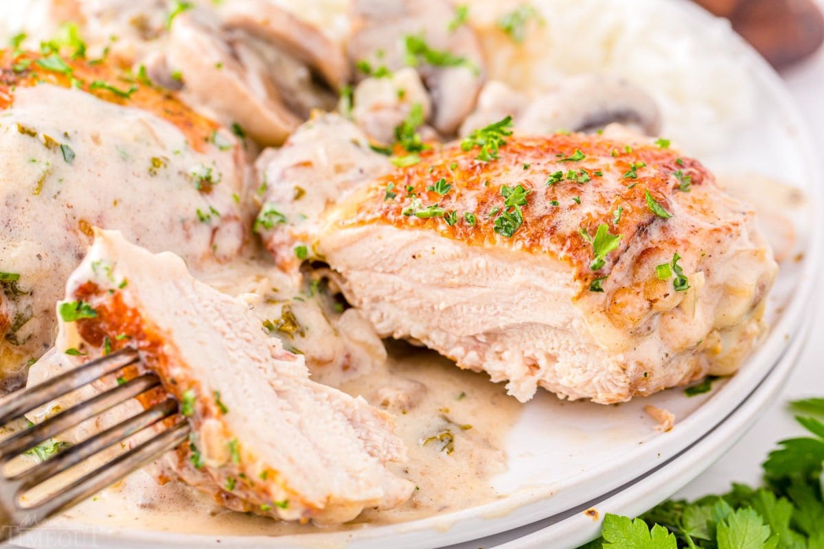 chicken thigh cut open to reveal juicy meat.