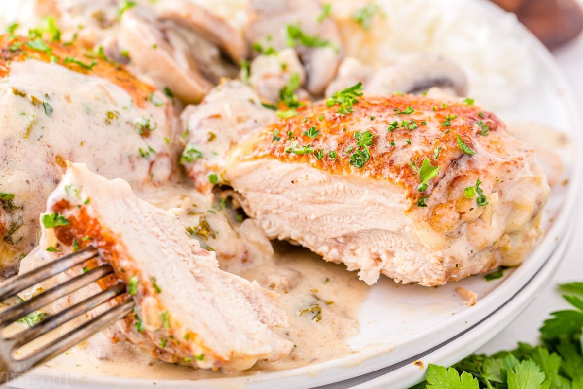 chicken thigh cut open to reveal juicy meat. 