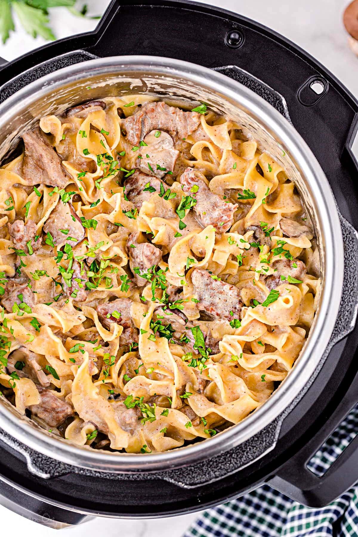 top down look at beef stroganoff cooked in the instant pot ready to serve and garnished with fresh parsley.