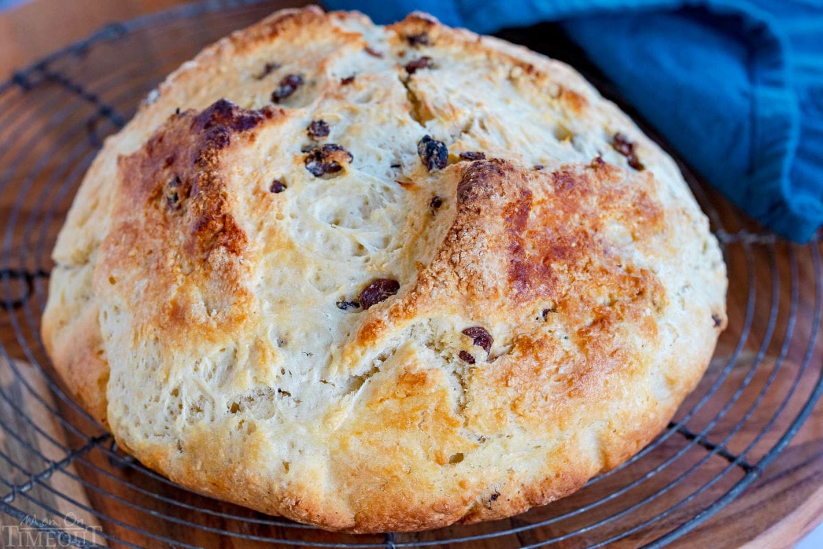 whole loaf of irish soda bread on wire rack cooling.