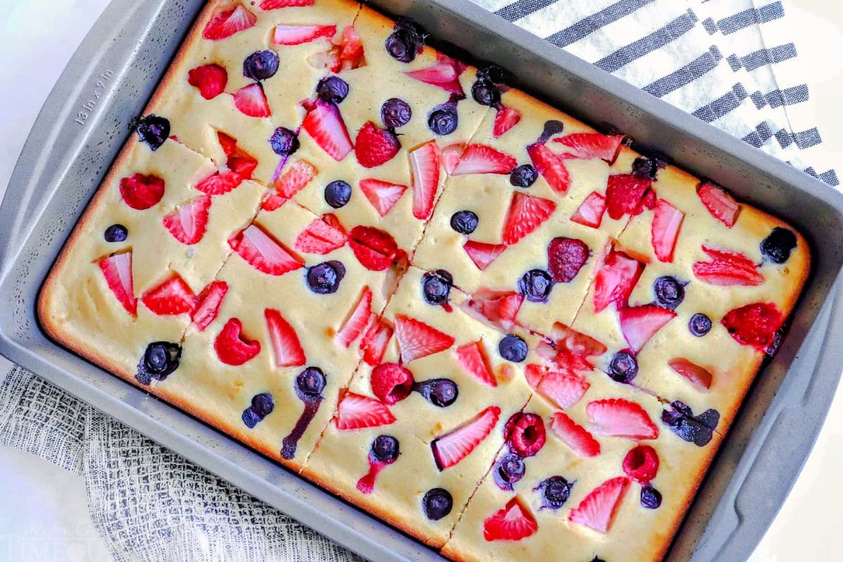 oven pancakes made in baking sheet and topped with strawberries, raspberries and blueberries. Baked and cut into pieces.