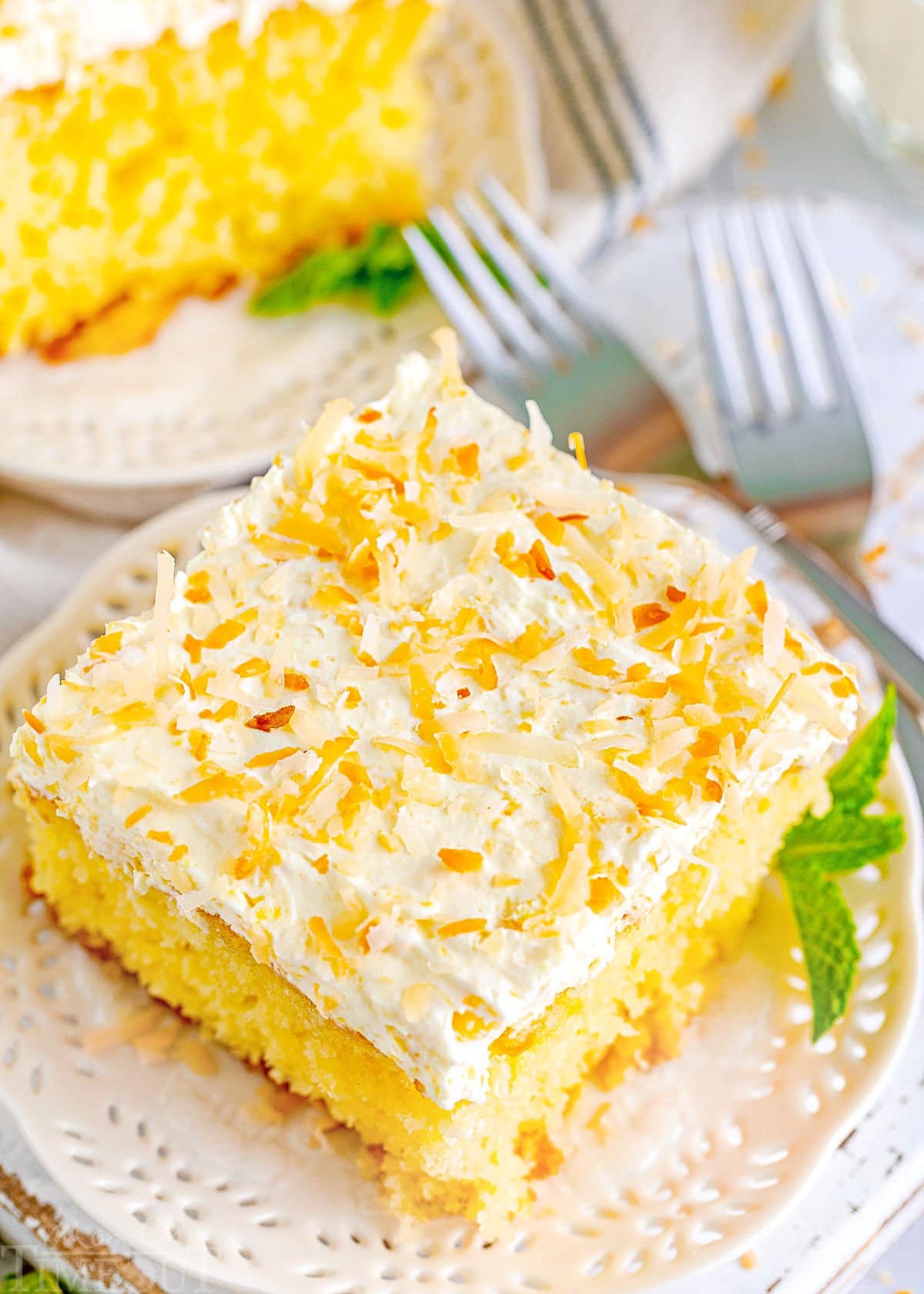 top down look at top of frosted pina colada cake recipe topped with toasted coconut.