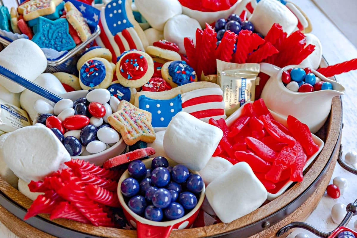 dessert board prepared for the 4th of July with red white and blue candy and treats.