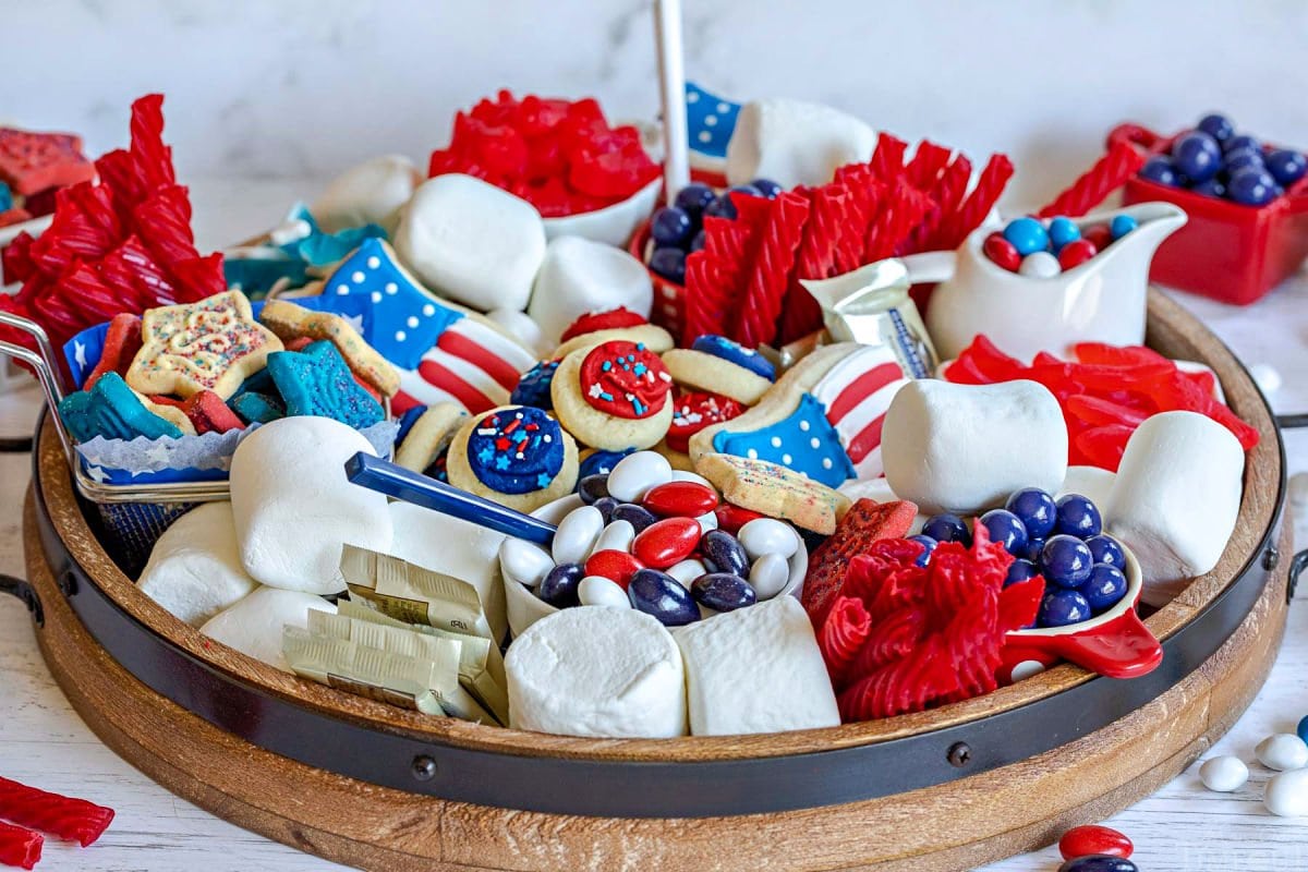 dessert board prepared for the 4th of July with red white and blue candy and treats.