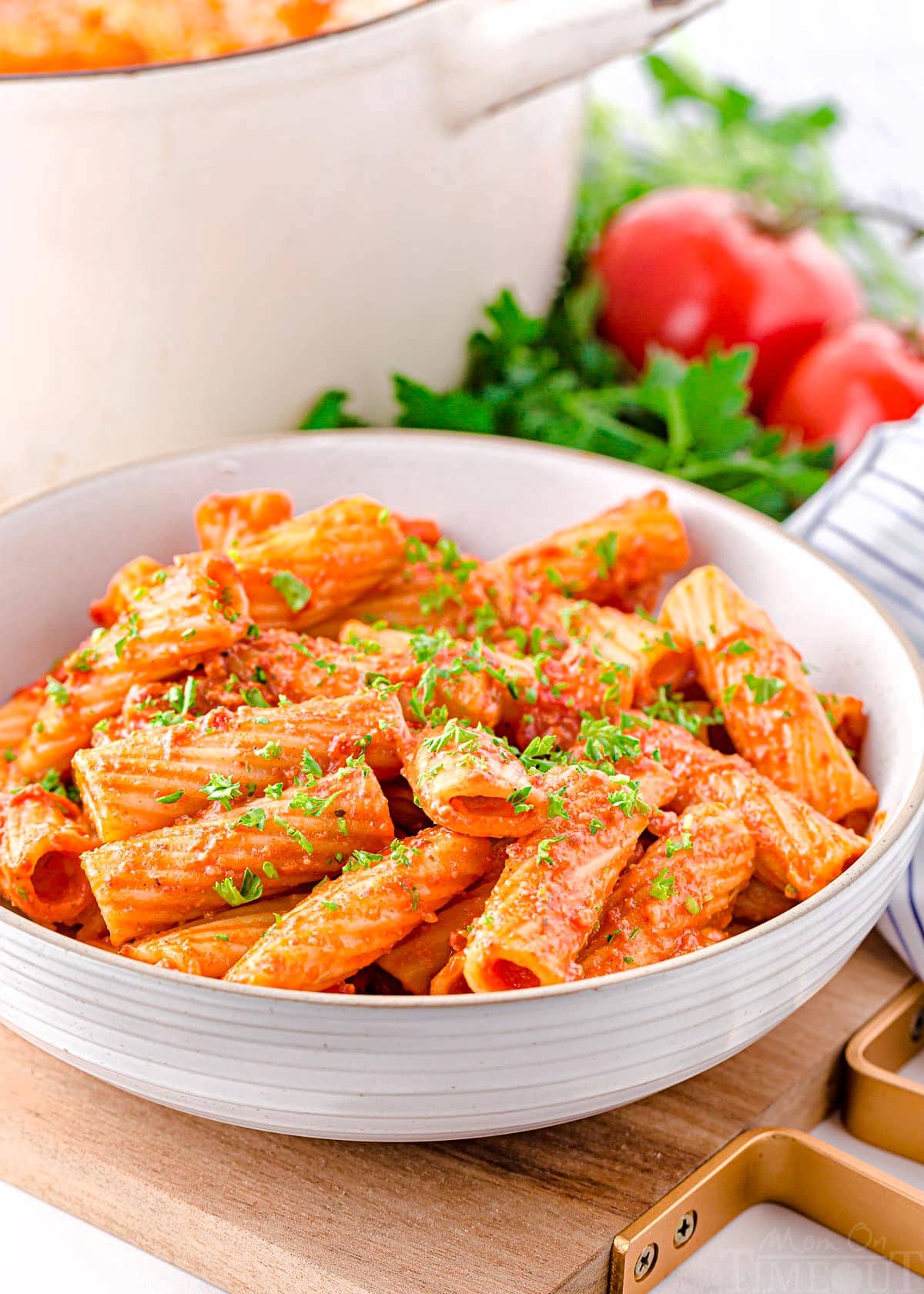 chorizo pasta in a large white pasta bowl sitting in front of large white pot.