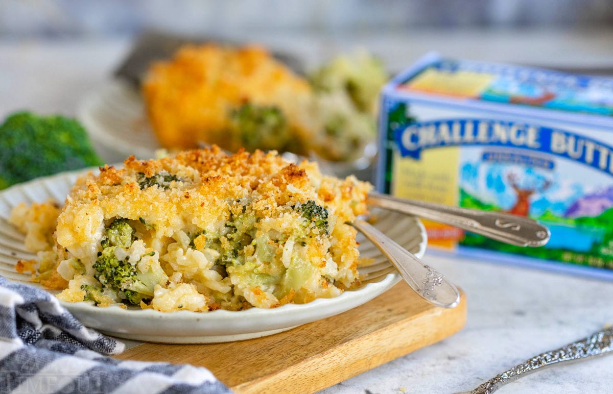 serving of broccoli casserole on a small plate with a box of butter in the background.