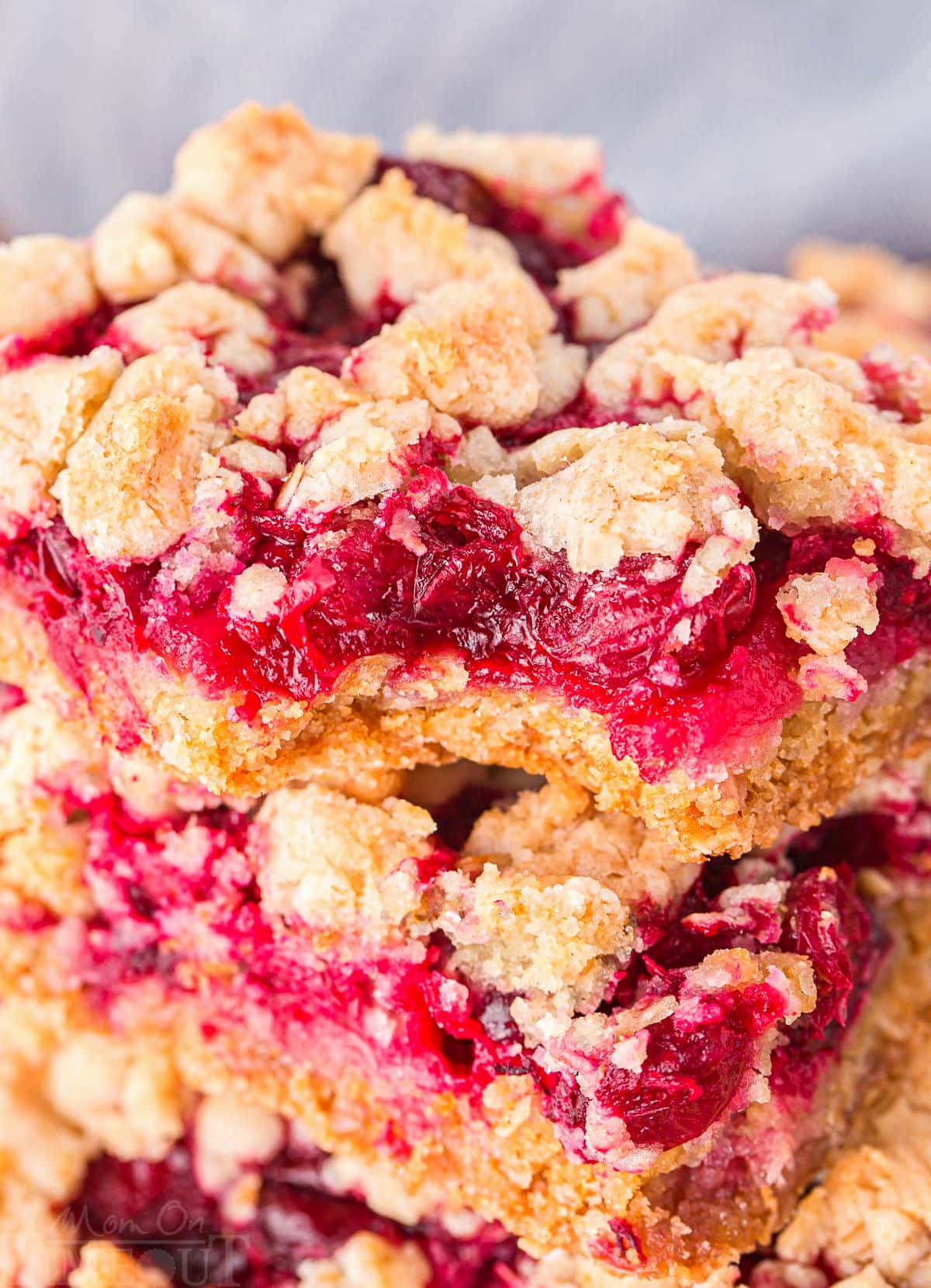 close up look at cranberry bars stacked on top of each other.